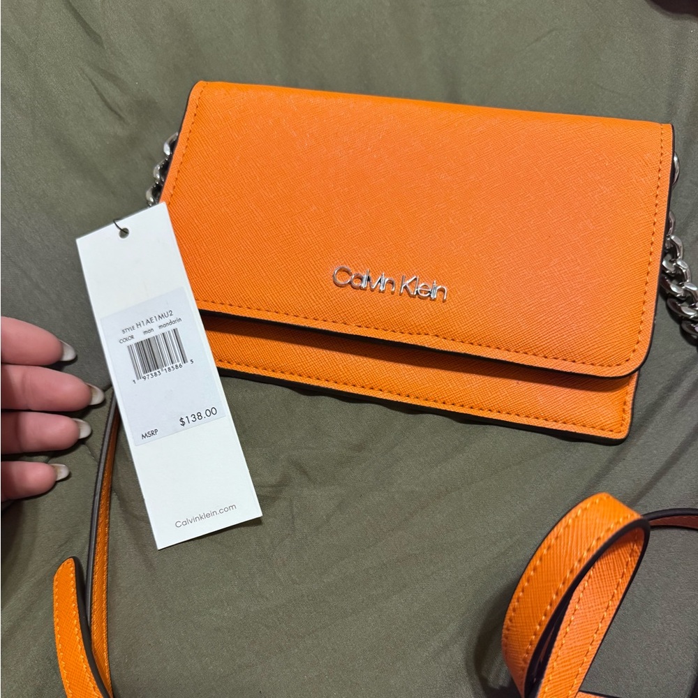 Orange Calvin Klein wallet/wristlet